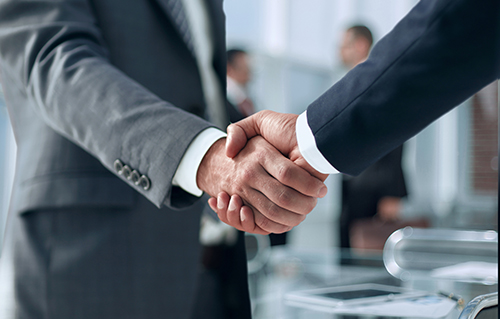 Business people shaking hands, happy with products and services from Primary Bank